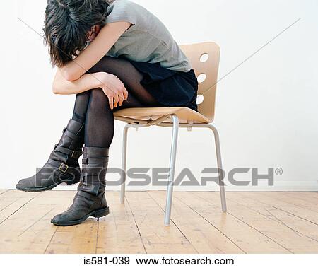 Sad woman on chair View Large Photo Image Stock Photo - Sad woman on chair. Fotosearch