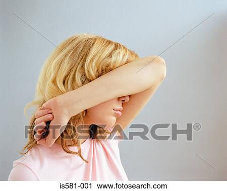 Stock Image - Woman covering face with arm. Fotosearch