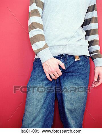 Stock Photography - Young man holding crotch. Fotosearch