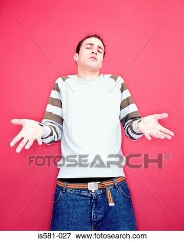 Young man shrugging View Large Photo Image Stock Photo - Young man shrugging. Fotosearch