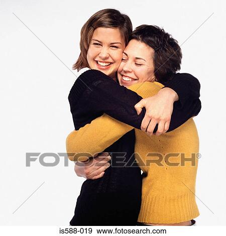 Female friends hugging View Large Photo Image Stock Photo - Female friends hugging. Fotosearch