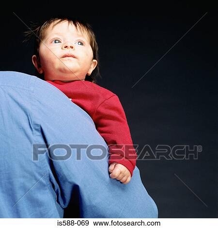Man holding a baby View Large Photo Image Stock Photo - Man holding a baby. Fotosearch