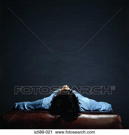 Man lying on a leather cushion View Large Photo Image Stock Image - Man lying on a leather cushion. Fotosearch