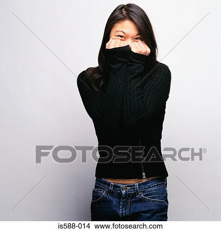 Woman covering face with sweater View Large Photo Image Picture - Woman covering face with sweater. Fotosearch
