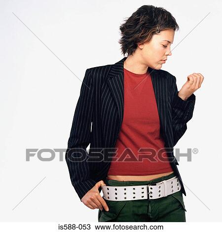 Stock Image - Woman looking at fingernails. Fotosearch