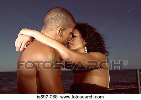 Couple hugging on beach View Large Photo Image Stock Photo - Couple hugging on beach. Fotosearch