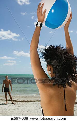 Couple playing beach ball View Large Photo Image Stock Photo - Couple playing beach ball. Fotosearch