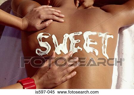 Stock Photography - Woman applying sun cream on man's back. Fotosearch