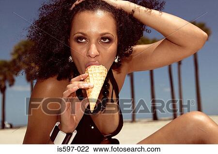 Woman eating ice cream on beach View Large Photo Image Stock Image - Woman eating ice cream on beach. Fotosearch