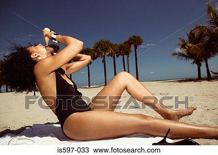 Woman eating ice cream on beach View Large Photo Image Stock Image - Woman eating ice cream on beach. Fotosearch