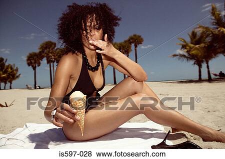 Woman eating ice cream on beach View Large Photo Image Stock Photo - Woman eating ice cream on beach. Fotosearch
