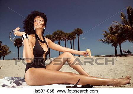 Woman sunbathing on beach View Large Photo Image Stock Photo - Woman sunbathing on beach. Fotosearch