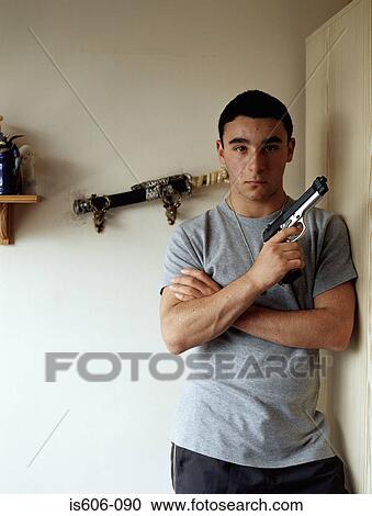 Stock Image - Boy holding a toy gun. Fotosearch