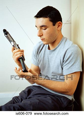 Stock Photo - Boy holding a toy gun. Fotosearch