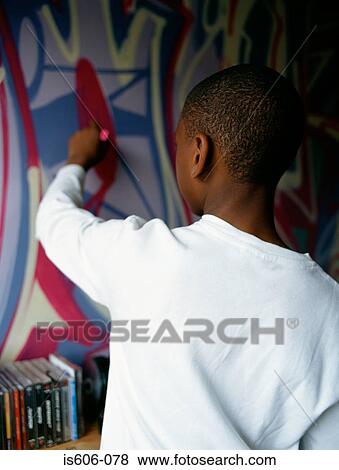 Boy painting graffiti on wall View Large Photo Image Stock Photo - Boy painting graffiti on wall. Fotosearch