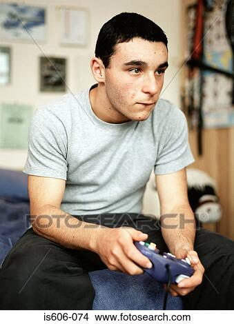 Boy playing a video game View Large Photo Image Picture - Boy playing a video game. Fotosearch