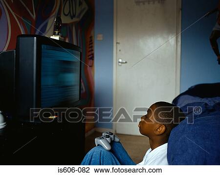 Stock Image - Boy playing a video game. Fotosearch