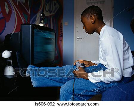 Boy playing a video game View Large Photo Image Stock Image - Boy playing a video game. Fotosearch
