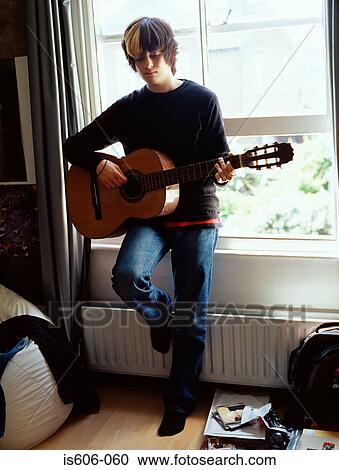 Boy playing acoustic guitar View Large Photo Image Stock Image - Boy playing acoustic guitar. Fotosearch