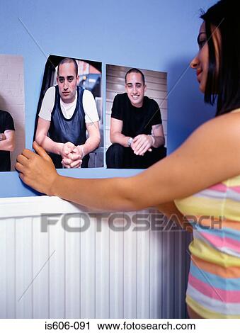 Girl attaching posters to wall View Large Photo Image Stock Image - Girl attaching posters to wall. Fotosearch