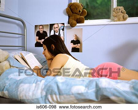 Girl reading on bed View Large Photo Image Stock Photo - Girl reading on bed. Fotosearch