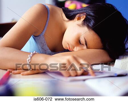 Stock Image - Girl sleeping at desk. Fotosearch