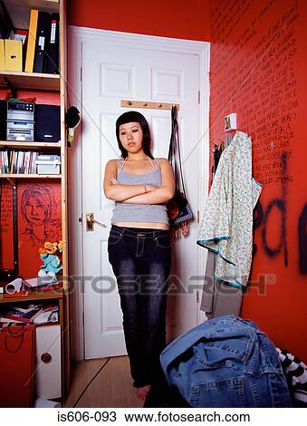 Stock Image - Hostile teenage girl in bedroom. Fotosearch