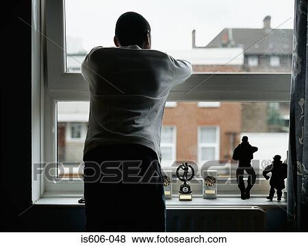 Silhouetted boy near window View Large Photo Image Stock Photo - Silhouetted boy near window. Fotosearch