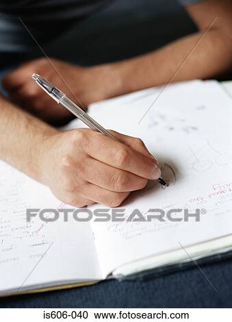 Stock Image - Teenage boy doing homework. Fotosearch
