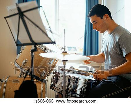 Teenage boy playing the drums View Large Photo Image Stock Image - Teenage boy playing the drums. Fotosearch