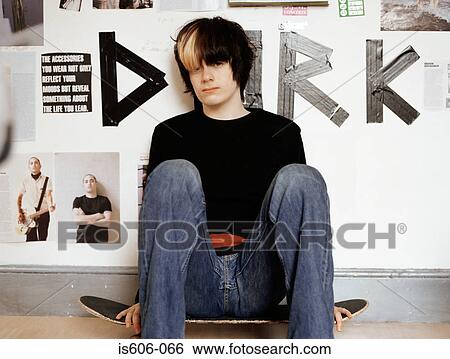 Teenage boy sitting on skateboard View Large Photo Image Stock Photograph - Teenage boy sitting on skateboard. Fotosearch