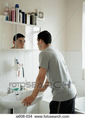 Teenage boy standing in bathroom View Large Photo Image Picture - Teenage boy standing in bathroom. Fotosearch