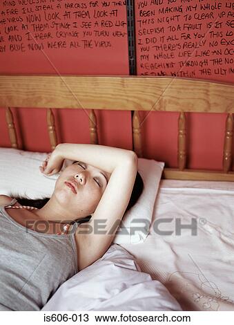 Stock Image - Teenage girl sleeping in bed. Fotosearch