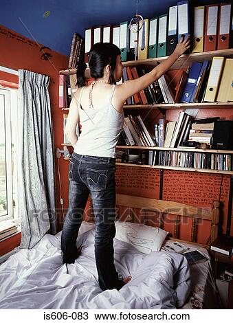 Teenage girl standing on bed View Large Photo Image Stock Image - Teenage girl standing on bed. Fotosearch