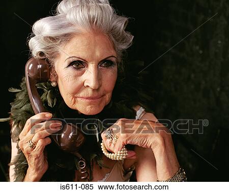 Glamorous senior woman on the telephone View Large Photo Image Stock Photography - Glamorous senior woman on the telephone . Fotosearch