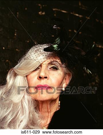 Stock Photo - Headshot of senior woman in hat looking at camera. Fotosearch