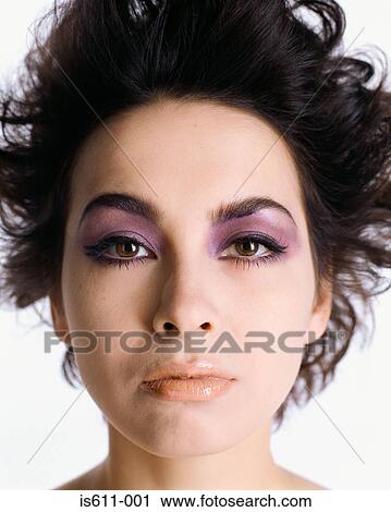 Stock Image - Headshot of woman wearing dramatic makeup. Fotosearch