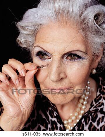Senior woman applying fake eyelashes View Large Photo Image Stock Photography - Senior woman applying fake eyelashes. Fotosearch