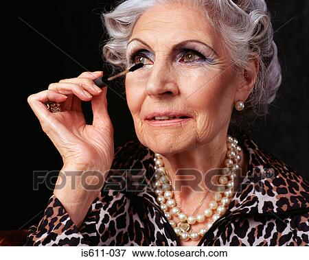 Senior woman applying mascara View Large Photo Image Stock Photo - Senior woman applying mascara. Fotosearch