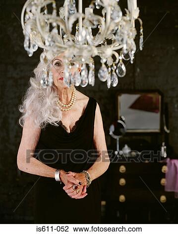 Senior woman behind chandelier View Large Photo Image Stock Image - Senior woman behind chandelier. Fotosearch