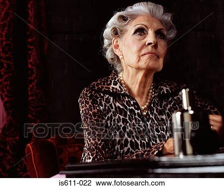 Stock Image - Senior woman looking thoughtful. Fotosearch