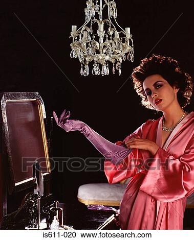 Young woman putting on satin glove View Large Photo Image Stock Image - Young woman putting on satin glove. Fotosearch