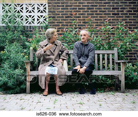 Stock Photograph - Elderly couple on a bench. Fotosearch