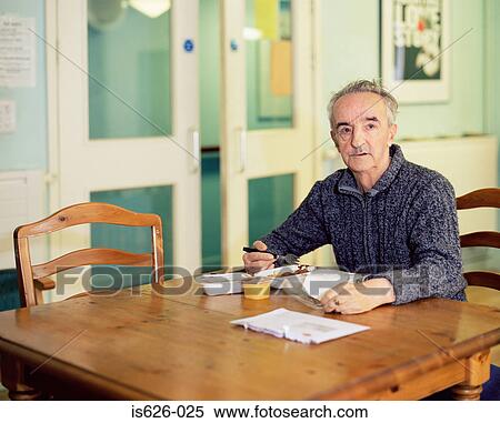 Stock Photography - Elderly man eating breakfast. Fotosearch
