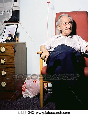 Elderly man in an armchair View Large Photo Image Stock Image - Elderly man in an armchair. Fotosearch