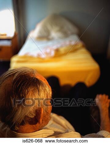 Elderly man in his room View Large Photo Image Stock Photo - Elderly man in his room . Fotosearch