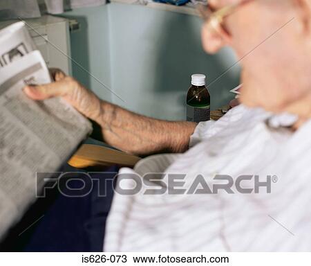 Elderly man reading a newspaper View Large Photo Image Stock Image - Elderly man reading a newspaper. Fotosearch