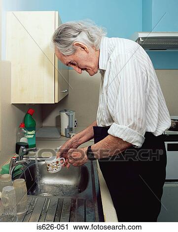Elderly man washing up View Large Photo Image Stock Image - Elderly man washing up. Fotosearch