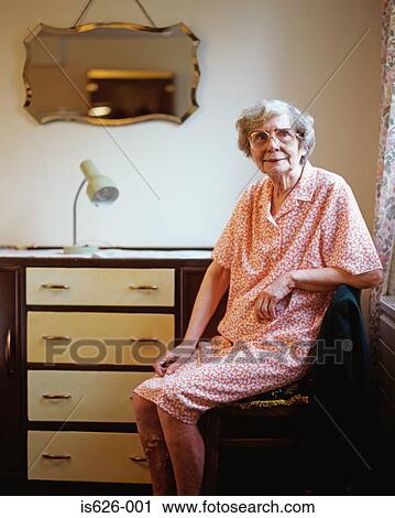 Stock Image - Elderly woman in her room . Fotosearch