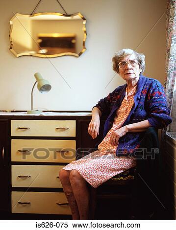 Stock Photography - Elderly woman in her room . Fotosearch